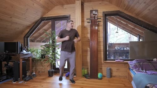 Man Jogging in Place During Home Cardio Workout