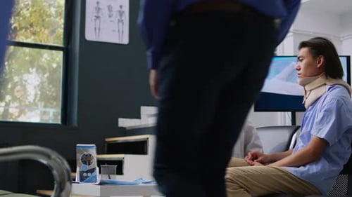 Doctor Explains Diagnosis to Patient with Neck Brace