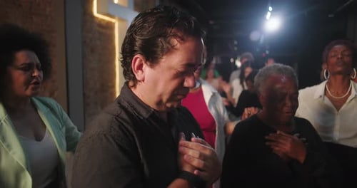 Diverse group of people with hands on chest in emotional prayer, deep connection to faith