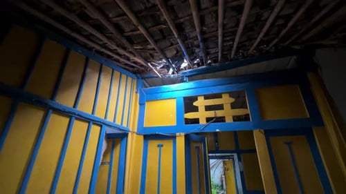 Interior Shot of Decaying Home with Ceiling Hole