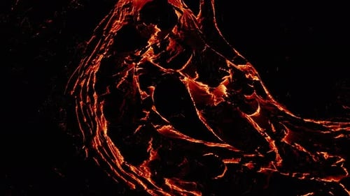 River of molten lava at night with solidifying black surface in Iceland