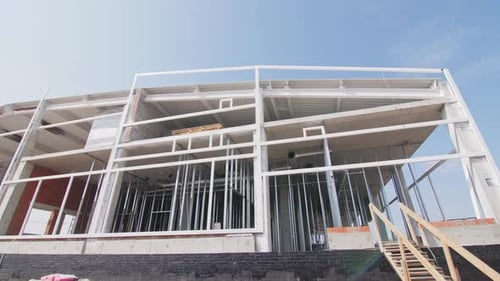Public Building with Facade and Metal Carcass Under Blue Sky