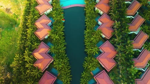 Luxurious Tropical Resort Featuring Vibrant Red Roofs Sparkling Pool Surrounding Verdant Palm Trees