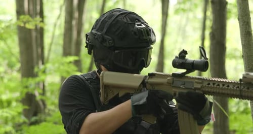 Tactical army guy switches from rifle to pistol in gun fight.