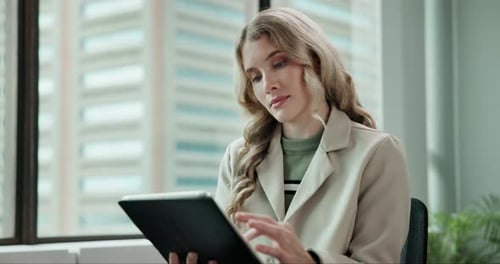 Woman Uses Tablet in an Office