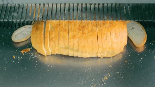 Automatic Bread Slicer Slicing Bread at the Bakery
