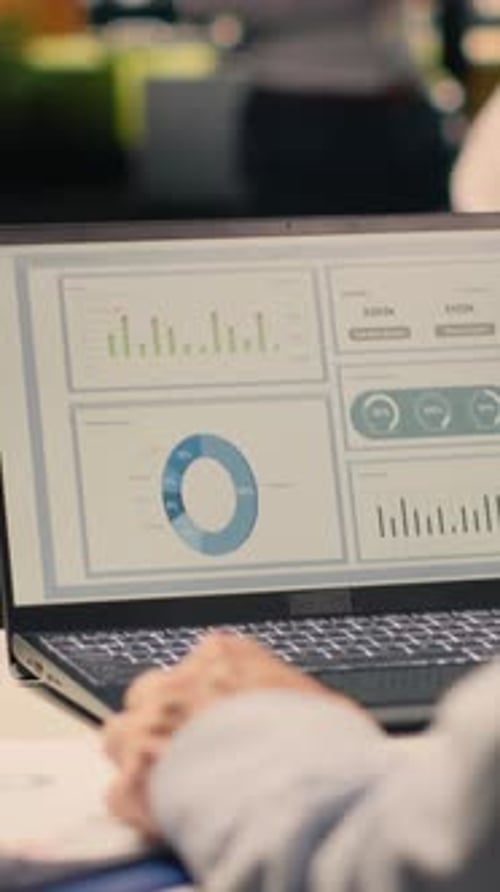 Vertical Video Male Office Worker Solving Tasks Independently on Laptop at Desk