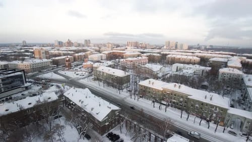 Cars Driving on Snowy Streets in a Residential District