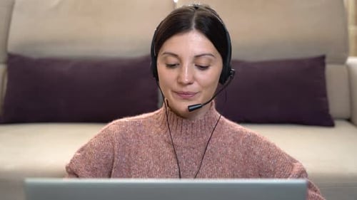 Woman Working Remotely on Laptop with Headset
