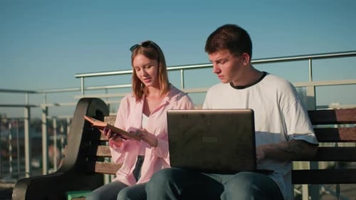 High School Students Studying Outdoors with City Background