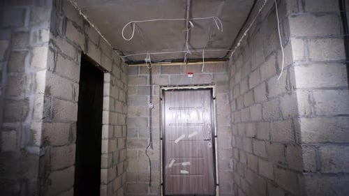 Unfinished Room with Cinder Block Walls and Door
