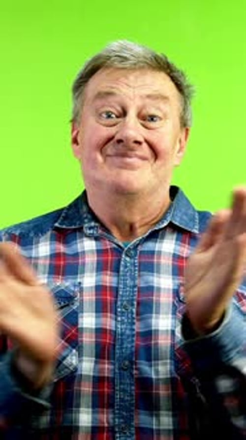 Smiling Senior Caucasian man applauding and expressing admiration.