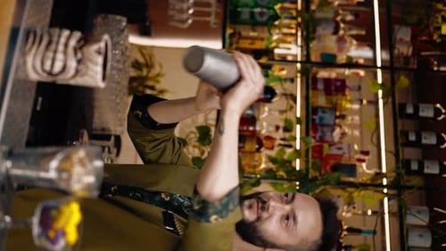 vertical video The process of making a cocktail in a bar A bartender mixes the ingredients