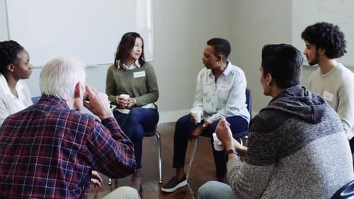 Diverse support group shares stories and finds comfort together in community center