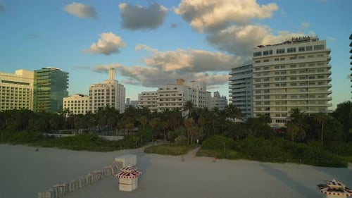 Aerial View of Miami's Beachfront at Sunset Featuring Highrise Buildings Set Against a Picturesque