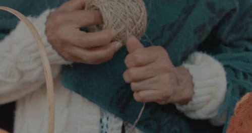 Slowmotion shot of a woman wrapping up a string