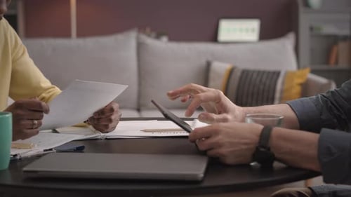 Business Meeting and Handshake in a Modern Living Room