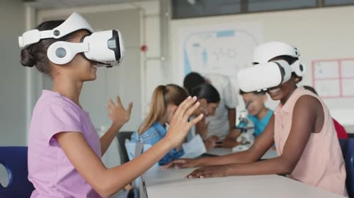 Using VR headsets, students exploring virtual reality in school classroom