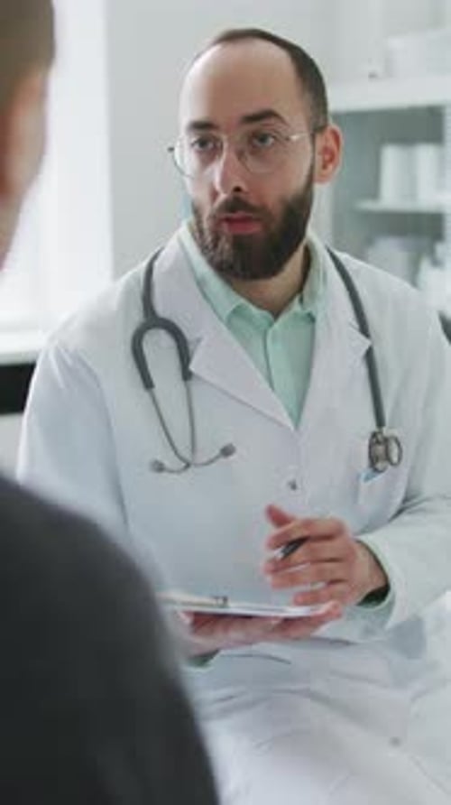 Doctor Consulting With Patient in Office