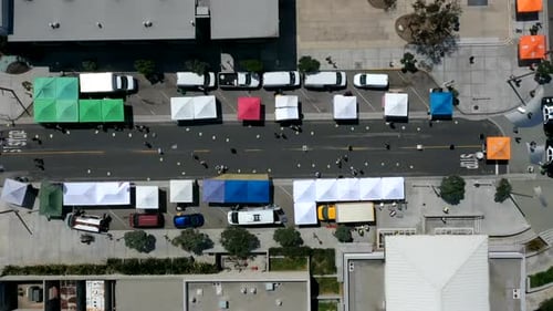 Colorful Canopy Tents Along The Street With People Walking. Farmer's Market In Manhattan Beach, Cali