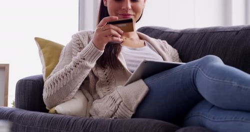 Woman Shops Online Using Tablet on Couch