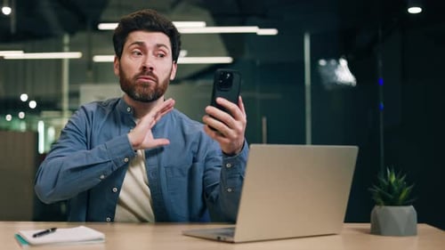 Bearded Man on Video Call in Office Setting