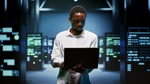 Smiling Data Center Employee Holding Laptop