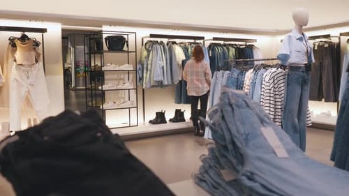 Girl Choosing Clothes in a Clothing Store Shop Shopping Concept
