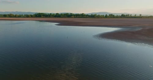 View of Water Surface and Dry Shore of Lake During Drought
