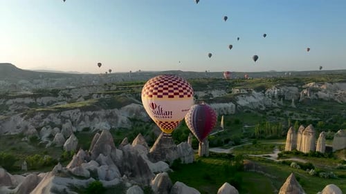Hot Air Balloons Fly Over the Mountainous Landscape of Cappadocia Turkey