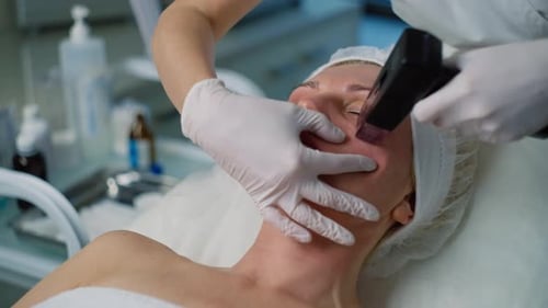 Woman Receiving Facial Medical Treatment in Clinic