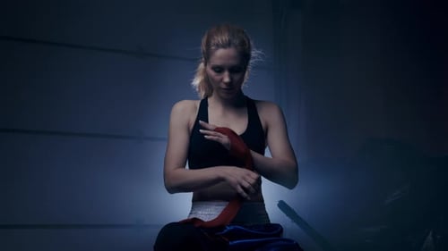 Woman Boxer Wrapping Hands Before Training