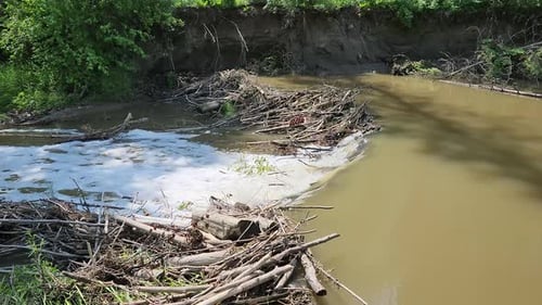 High Water Over Beaver Dam, Close-Up of Spring Runoff Flow. Close-up side view of muddy water