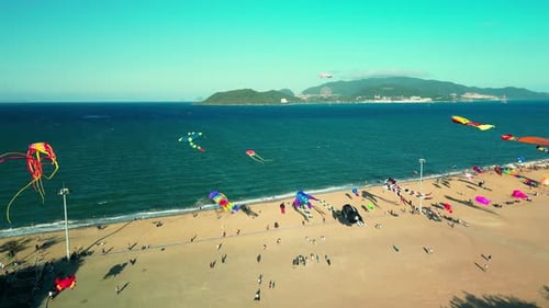 A Flying Kite Parade Colored Kites Flies in the Air Shape of a Yellow Octopus Against a Blue Sky at
