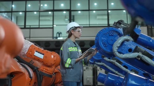 Engineer woman working inside robotic factory - Tech industry concept