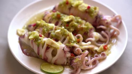 Seasoned Squid with Green Sauce on White Plate