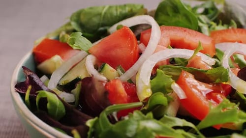 Pouring Olive Oil on Healthy Fresh Vegetables Vegan Salad Close Up Delicious Diet Salad of Tomato