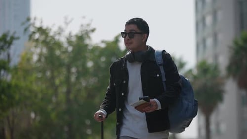 Latin Male Traveler Observing Urban Area with Suitcase and Passport