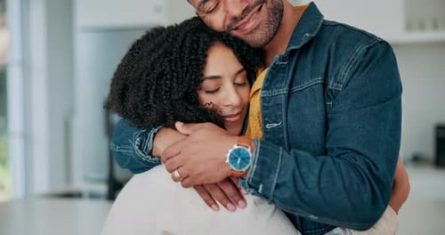 Loving Couple Embracing in Bright Home Kitchen