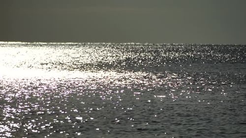 Abstract Shining Sun Reflections on Blue Surface of Sea Waves