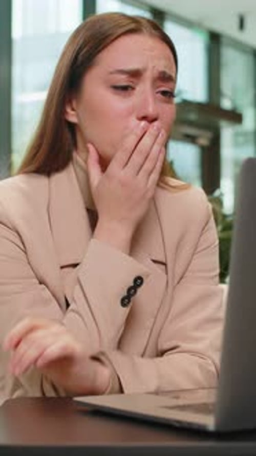 Distressed woman reacting to news on computer
