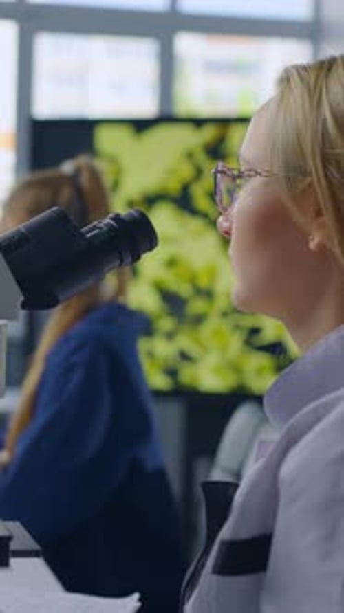Woman Scientist Using Microscope in Lab, close-up, portrait