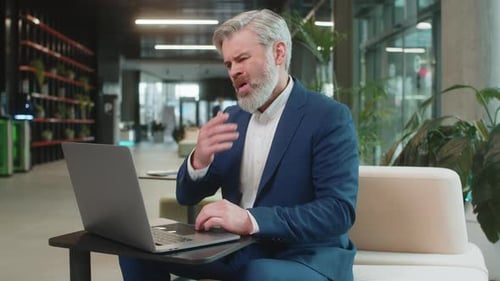 Sad Businessman Using Laptop Loses Becoming Shocked Sudden Lottery Results in Modern Hotel Lobby
