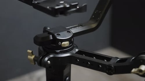 Adjusting a Black Camera Gimbal Device Close Up