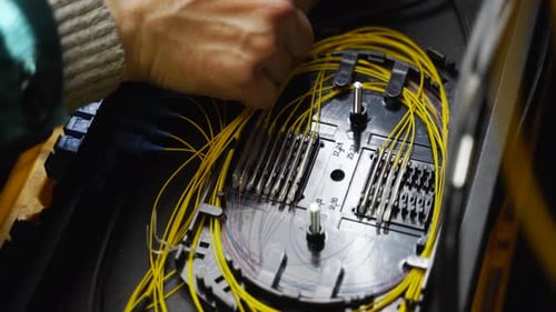 Worker Connects Optical Line Internet Wire in Connection Box Service Man Soldering Optical Fiber