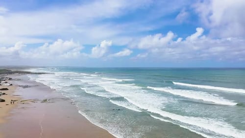 Aerial view of sandy beaches and waves.