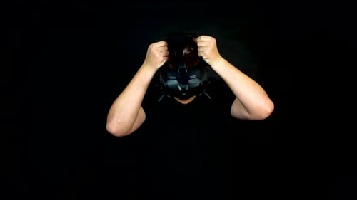 Young Man Wearing VR First Person View Headset, Studio Shot on Black Background