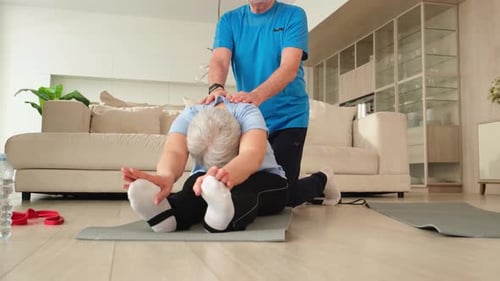 Senior Couple Stretching Together on Exercise Mats