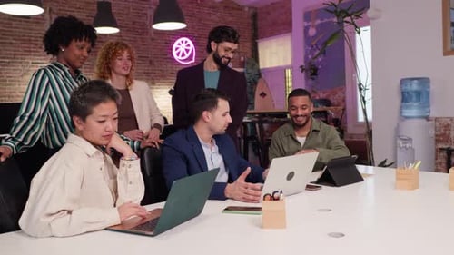 Coworkers Collaborating on Project in Modern Office in Slow Motion