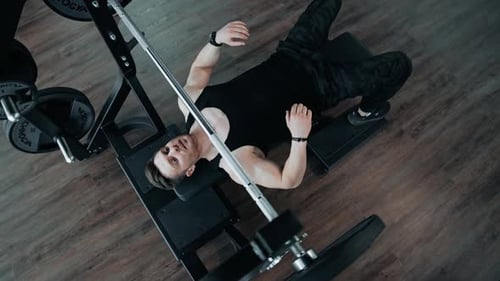 Muscular Man Doing Barbell Exercise. Man working out barbell bench press in the gym